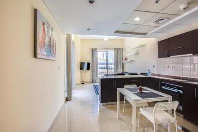 a kitchen with a table and chairs in a room at Bay Central 1BD apartment with awesome Marina view in Dubai