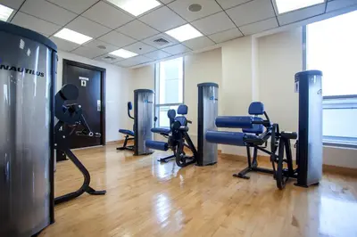 a gym with treadmills and exercise equipment in a room at Bay Central 1BD apartment with awesome Marina view in Dubai