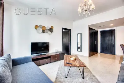 a living room with a couch and a table at Al Majara, Tower 1, Dubai Marina in Dubai