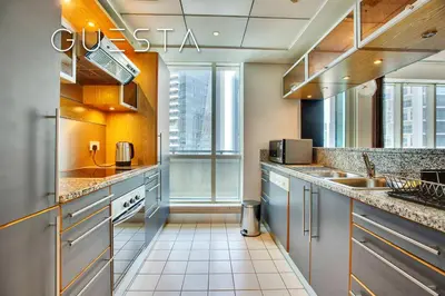 a kitchen with stainless steel appliances and a large window at Al Majara, Tower 1, Dubai Marina in Dubai