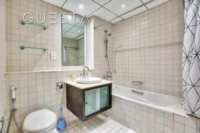 a bathroom with a sink and a tub and a toilet at Al Majara, Tower 1, Dubai Marina in Dubai