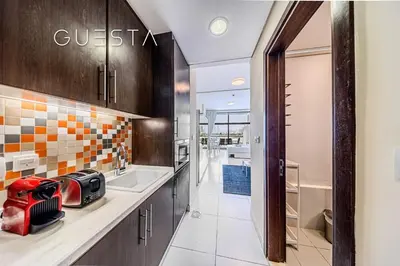 a kitchen with a sink and a counter top at Club Vista Mare, free Riva beach club access in Dubai