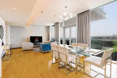a dining room with a glass table and chairs at Bluewaters Island - High-Floor 1 Bedroom Suite by Livbnb in Dubai
