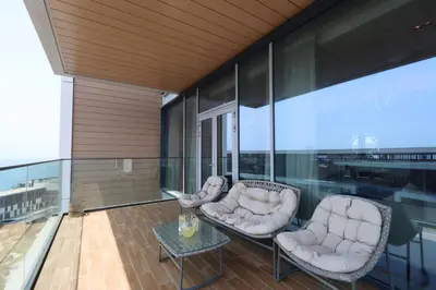 two chairs and a table on a balcony at Bluewaters Island - High-Floor 1 Bedroom Suite by Livbnb in Dubai
