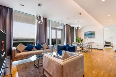 a living room with a couch and a table at Bluewaters Island - High-Floor 1 Bedroom Suite by Livbnb in Dubai