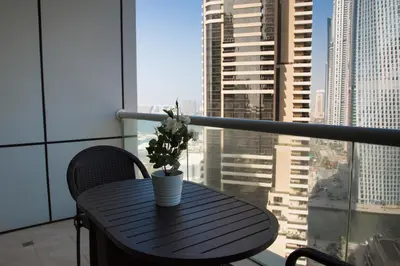 a black table with a plant on top of a balcony at HiGuests - Studio With Incredible Sea Views, 3-min to Beach in Dubai