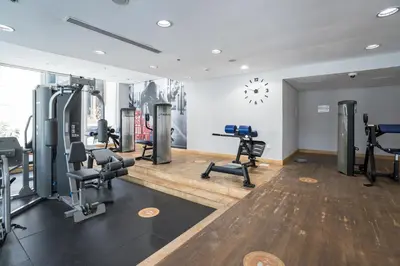 a gym with several treadmills and machines in a room at HiGuests - Studio With Incredible Sea Views, 3-min to Beach in Dubai