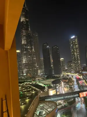 a view of a city at night with tall buildings at Address Dubai Mall Fashion Avenue 1 bedroom 34 floor in Dubai