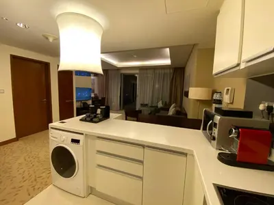 a kitchen with a washer and dryer on a counter at Address Dubai Mall Fashion Avenue 1 bedroom 34 floor in Dubai