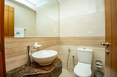a bathroom with a white toilet and a sink at Stylish and Sleek 1 Bed + Study near the JBR beach in Dubai
