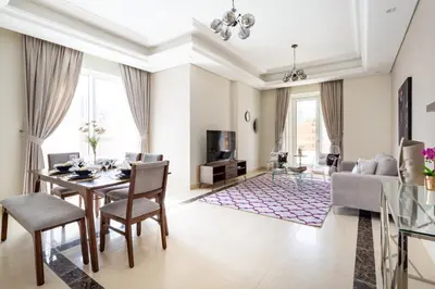 a living room with a table and chairs and a couch at Frank Porter - Mon Reve in Dubai