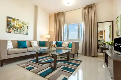a living room with a couch and a table at Staycae Holiday Homes - Suburbia in Dubai
