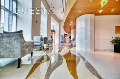 a lobby with a couch and chairs in a building at Marina Promenade - Paloma Tower, Dubai Marina in Dubai