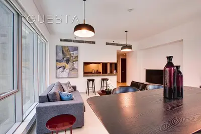 a living room with a table and a couch at Marina Promenade - Paloma Tower, Dubai Marina in Dubai
