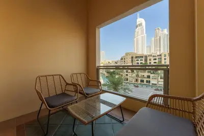 a waiting room with chairs and a table and a large window at Maison Privee - Exclusive Duplex Villa with Panoramic Terrace Overlooking Burj Khalifa in Dubai