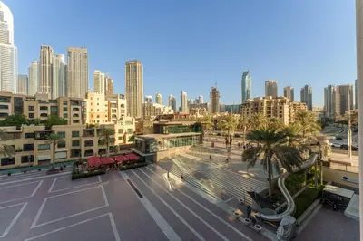 a city skyline with tall buildings and palm trees at Maison Privee - Exclusive Duplex Villa with Panoramic Terrace Overlooking Burj Khalifa in Dubai