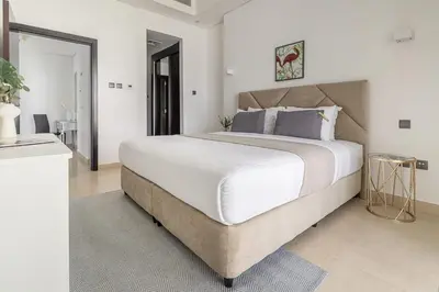 a bedroom with a large bed with white sheets at Frank Porter - Mon Reve in Dubai