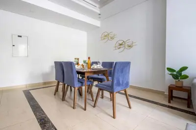 a dining room with a table and blue chairs at Frank Porter - Mon Reve in Dubai