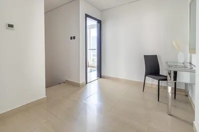 an empty white room with a desk and a chair at Frank Porter - Mon Reve in Dubai