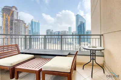 a balcony with a table and chairs and a view of the city at Close to Burj Khalifa & Dubai Mall with Relaxing Balcony, Claren Tower 1, Downtown Dubai by Deluxe Holiday Homes in Dubai