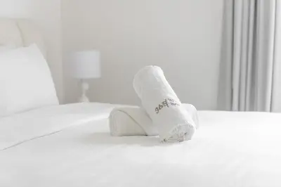a roll of toilet paper sitting on top of a bed at Island Paradise - Stylish 1BR on Bluewaters Island in Dubai
