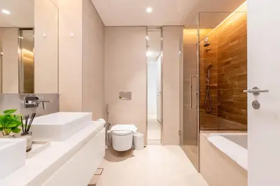 a bathroom with two sinks and a shower and a toilet at Island Paradise - Stylish 1BR on Bluewaters Island in Dubai