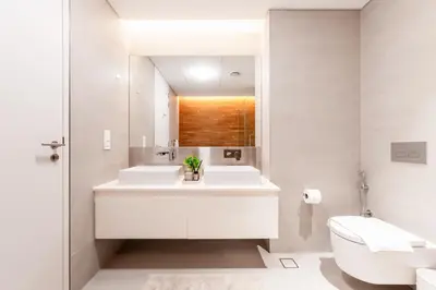 a bathroom with a sink and a toilet and a mirror at Island Paradise - Stylish 1BR on Bluewaters Island in Dubai