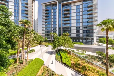 an image of a building with palm trees and a sidewalk at Island Paradise - Stylish 1BR on Bluewaters Island in Dubai
