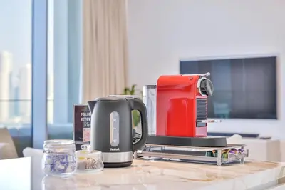 a coffeemaker sitting on a table with a coffee maker at Lavish & Equipped oceanfront 2 BR facing Ain Dubai in Dubai