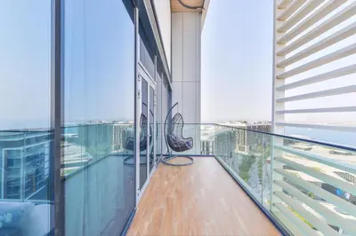 a balcony in a building with a view of the city at Spectacular 3 BR condo with maids room facing the Dubai Eye in Dubai