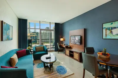 a living room with a couch and a table at Royal Continental Suites Business Bay - Deluxe Apartments in Dubai