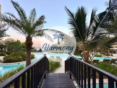a walkway leading to the entrance to the honeymoon resort at Harmony Vacation Homes - South Residence in Dubai