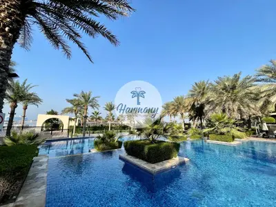 a large swimming pool with a sign that reads moroccan inn at Harmony Vacation Homes - South Residence in Dubai