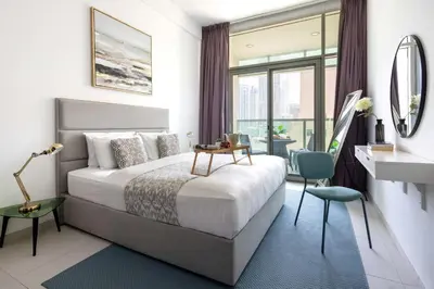 a bedroom with a bed and a desk and a window at Frank Porter - Panoramic Tower in Dubai