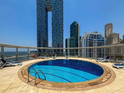 a swimming pool on top of a building with tall buildings at Frank Porter - Panoramic Tower in Dubai