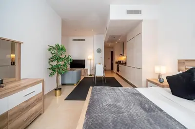 a bedroom with a bed and a living room at HiGuests - Unique Studio With Stunning Panoramic Marina Views in Dubai