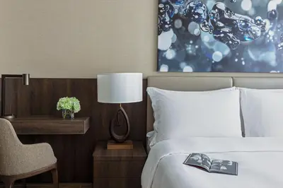 a hotel room with a bed and a desk with a chair at Jumeirah Living Marina Gate in Dubai