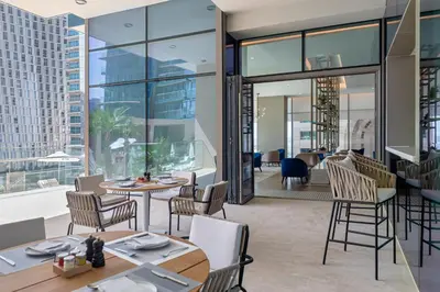 a restaurant with tables and chairs and a view of the city at Jumeirah Living Marina Gate in Dubai
