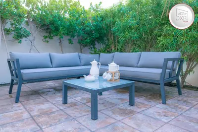 a blue couch and a table on a patio at 5 bedroom Villa - Dubai Hills in Dubai