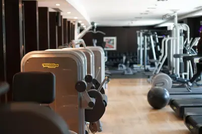 a gym with rows of tread machines and suitcases at Elite Royal Apartment - Onyx in Dubai