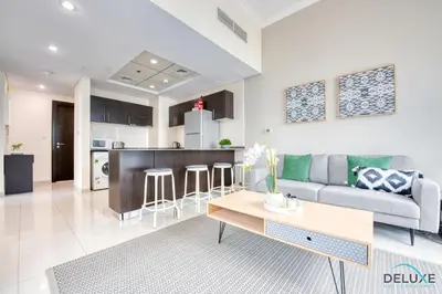 a living room and kitchen with a couch and a table at Overlooking Marina Canal 1BR Close to Mall, Promenade & Beach, Bay Central 1, Dubai Marina by Deluxe Holiday Homes in Dubai