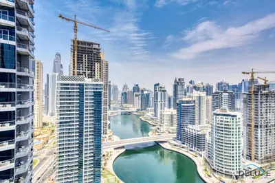 a view of a city with a river and buildings at Overlooking Marina Canal 1BR Close to Mall, Promenade & Beach, Bay Central 1, Dubai Marina by Deluxe Holiday Homes in Dubai