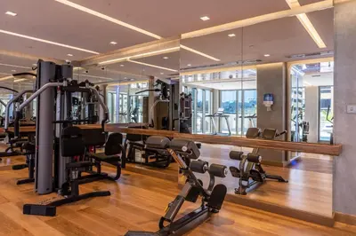 a gym with treadmills and cardio equipment in a building at SUHA Mina Rashid Hotel Apartments in Dubai