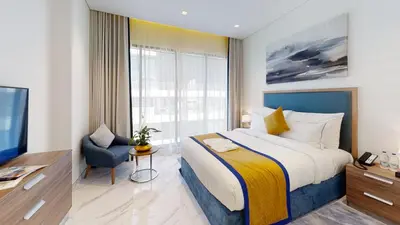 a hotel room with a bed and a window at SUHA Mina Rashid Hotel Apartments in Dubai