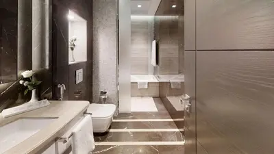 a bathroom with a toilet and a sink and a shower at SUHA Mina Rashid Hotel Apartments in Dubai
