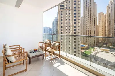 a balcony with chairs and a view of a city at Frank Porter - Trident Grand in Dubai