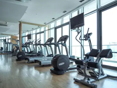 a gym with a bunch of treadmills and machines at Frank Porter - Trident Grand in Dubai