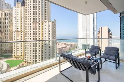 a balcony with two chairs and a view of the city at Frank Porter - Trident Grand in Dubai