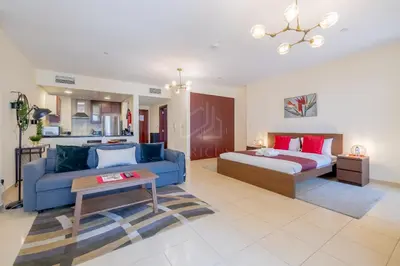 a living room with a bed and a couch at Modern and new studio in Murjan, JBR in Dubai