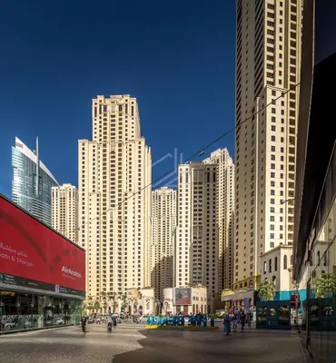 a city with tall buildings and people walking in the street at Modern and new studio in Murjan, JBR in Dubai